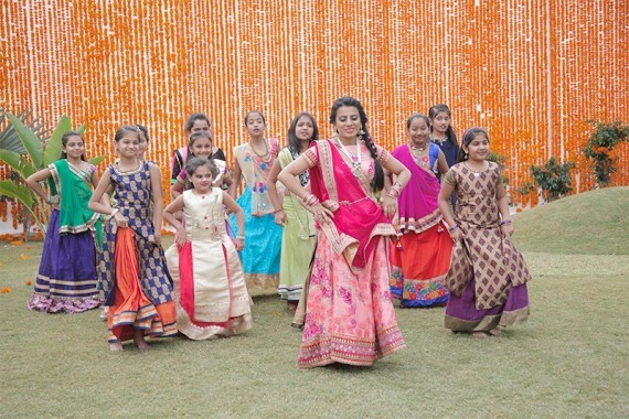 Bollywood dancer teaching a group of young Indian girls how to dance